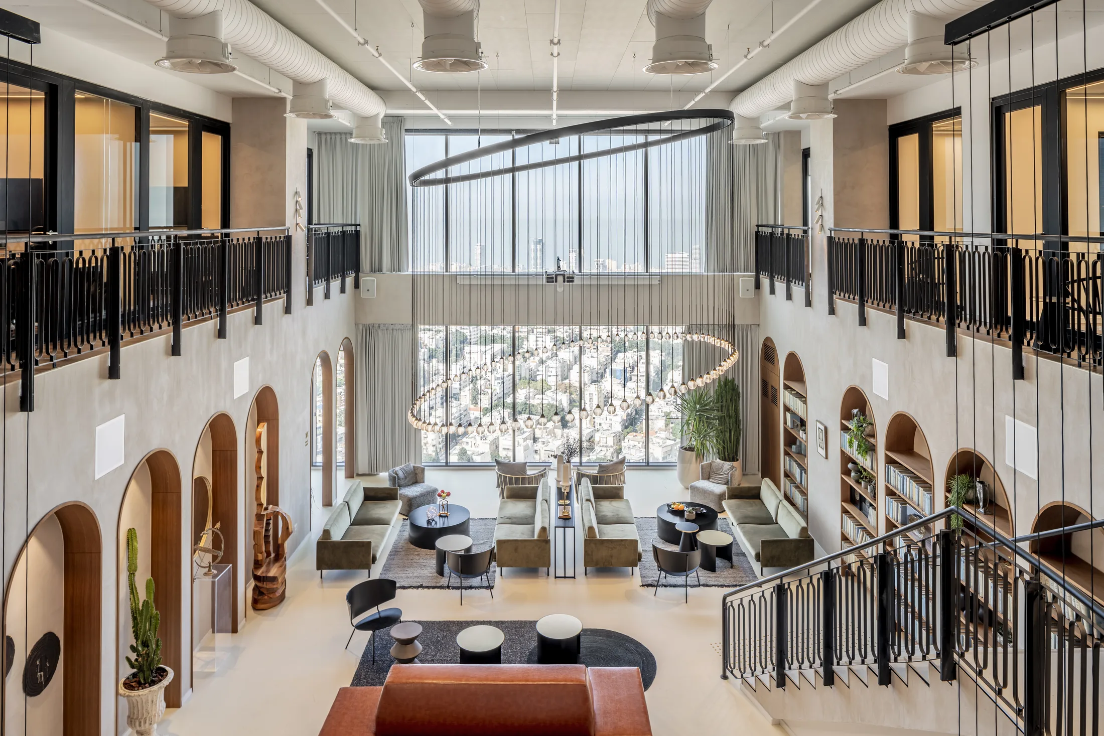 An elevated view of the double-height business lounge and its ring chandelier