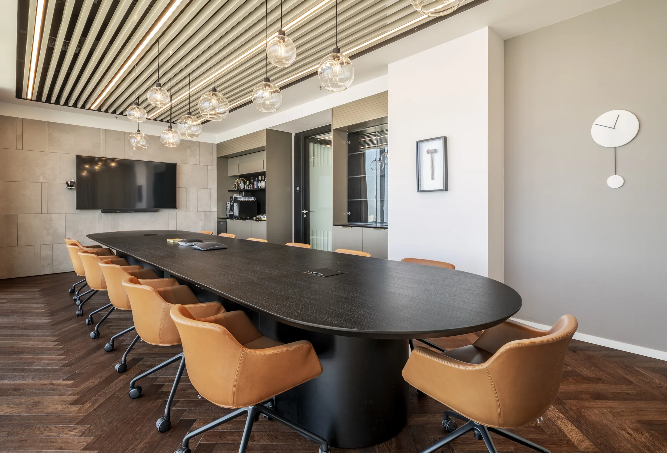 A meeting room with glass-globe pendants and a timber-slat ceiling
