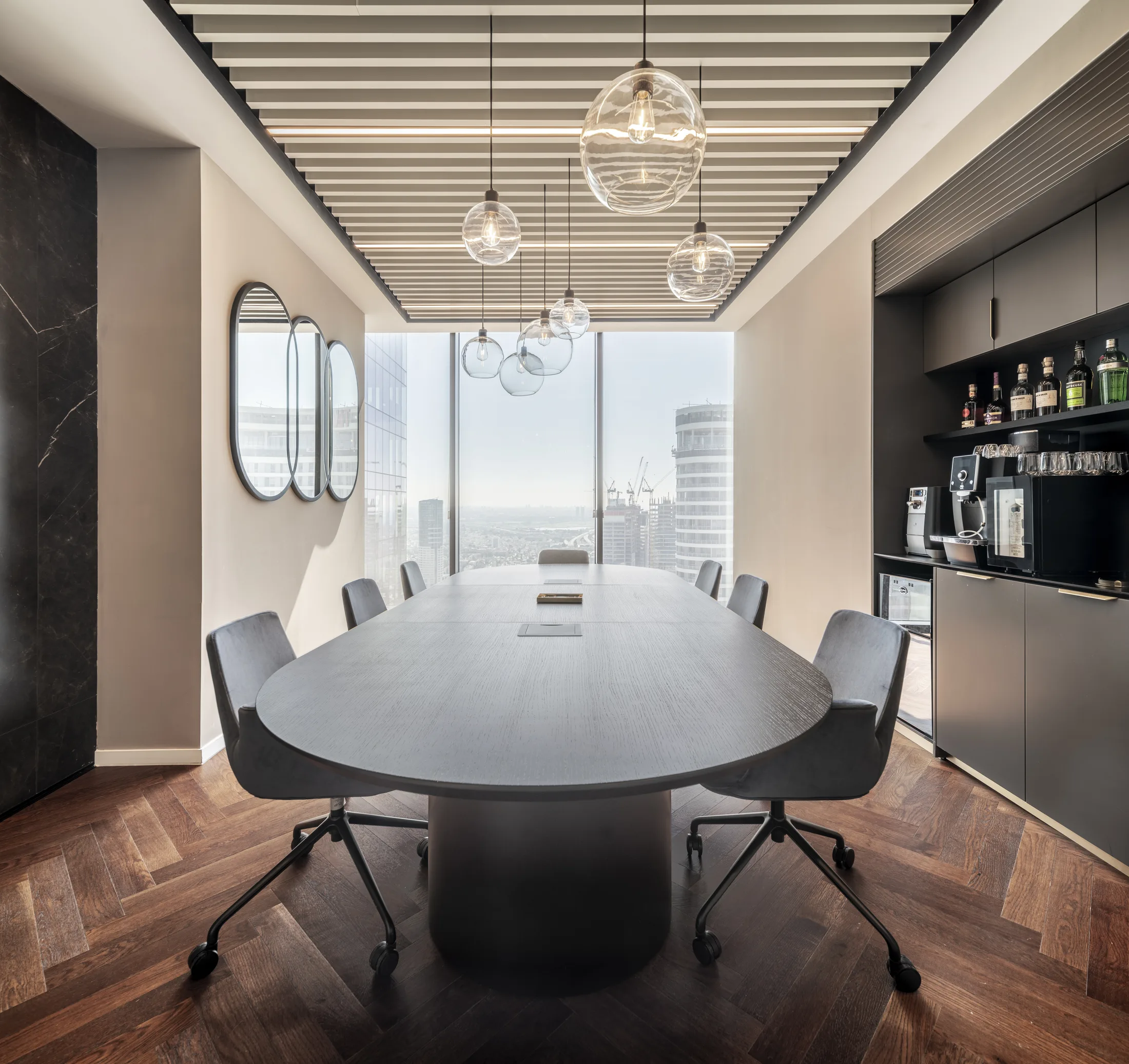 A meeting room with glass pendants and a Tel Aviv city view