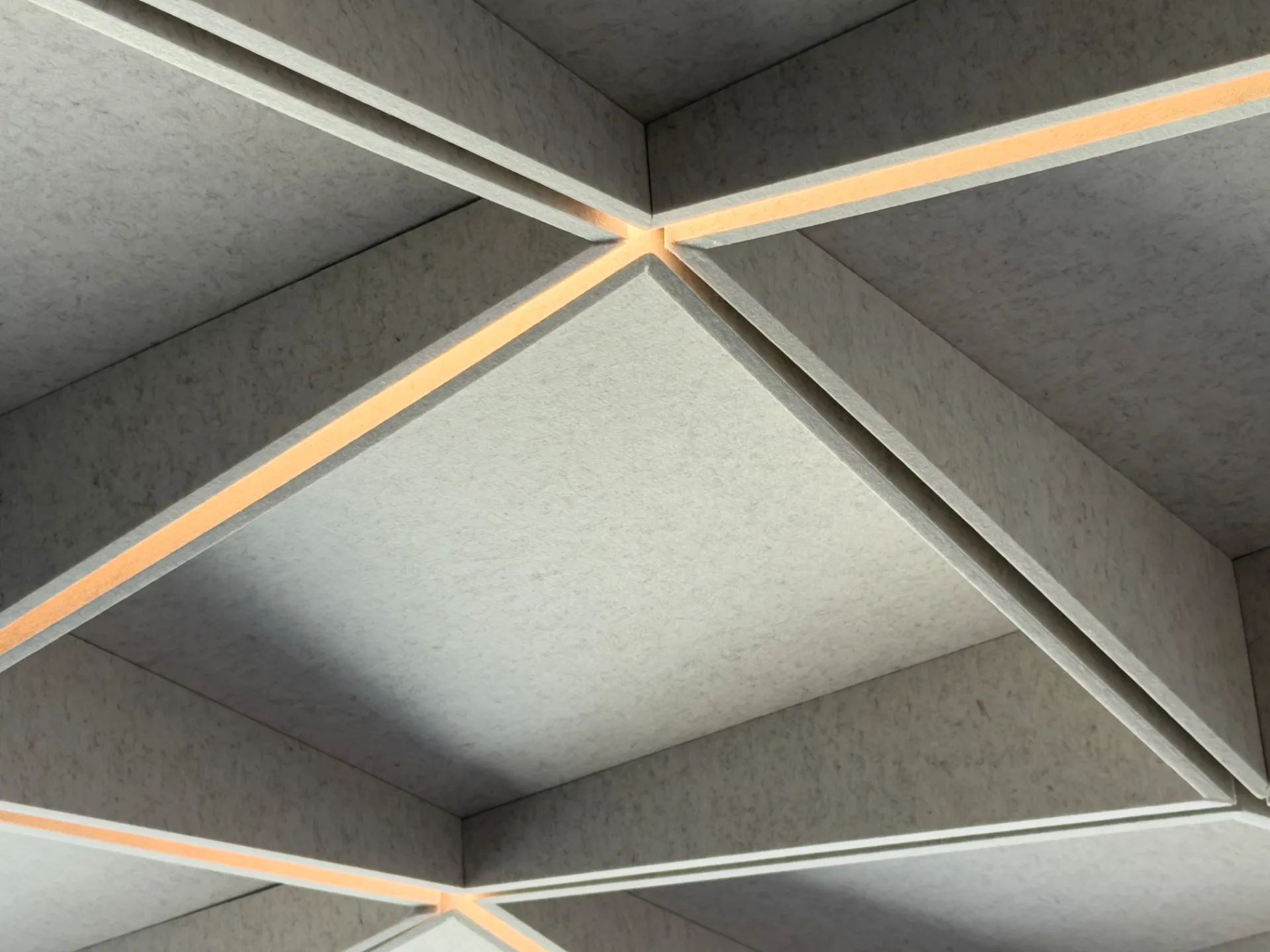 Detail of an amber light seam in the felt ceiling