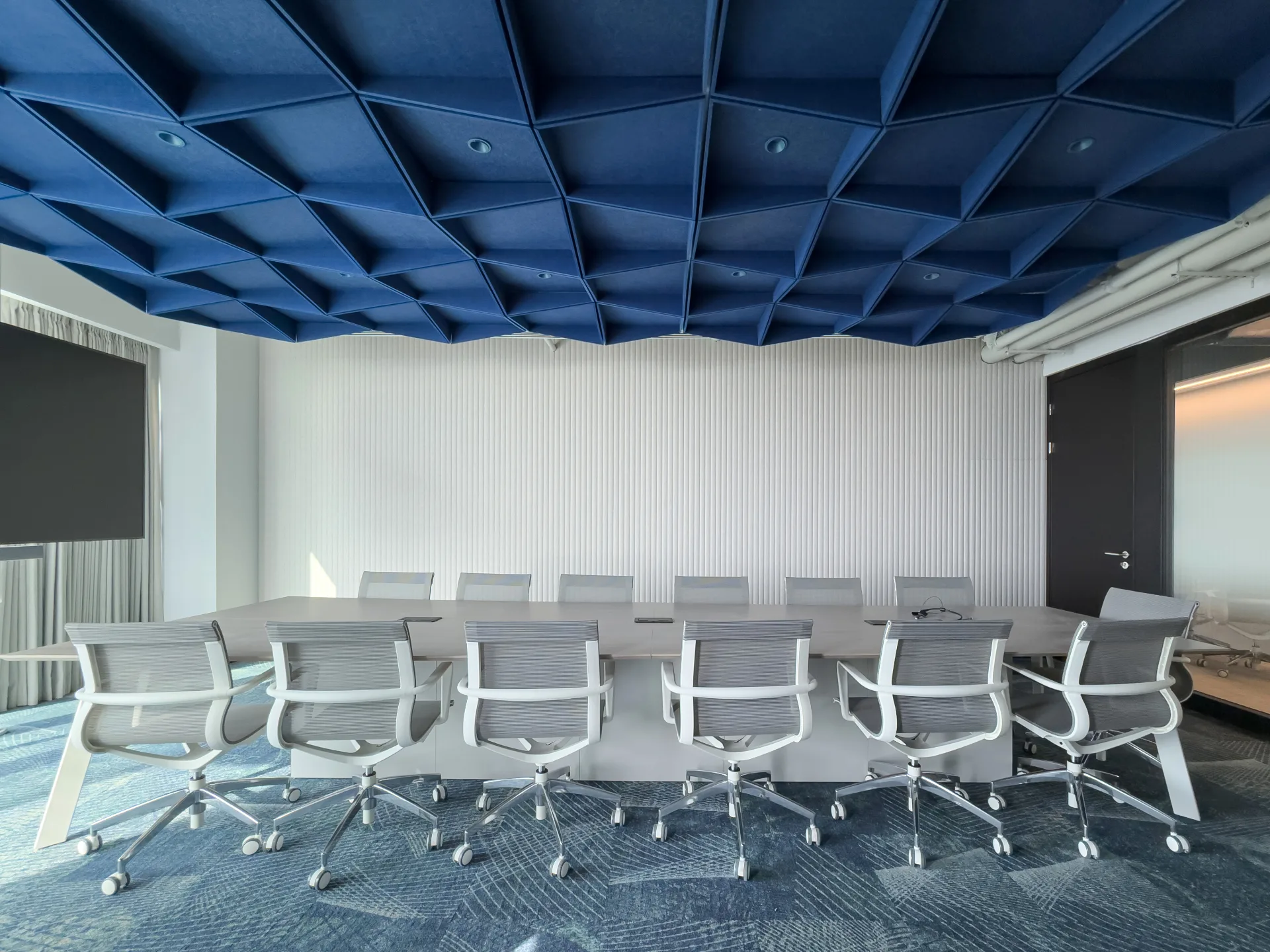 Boardroom with a blue felt ceiling and a fluted felt wall