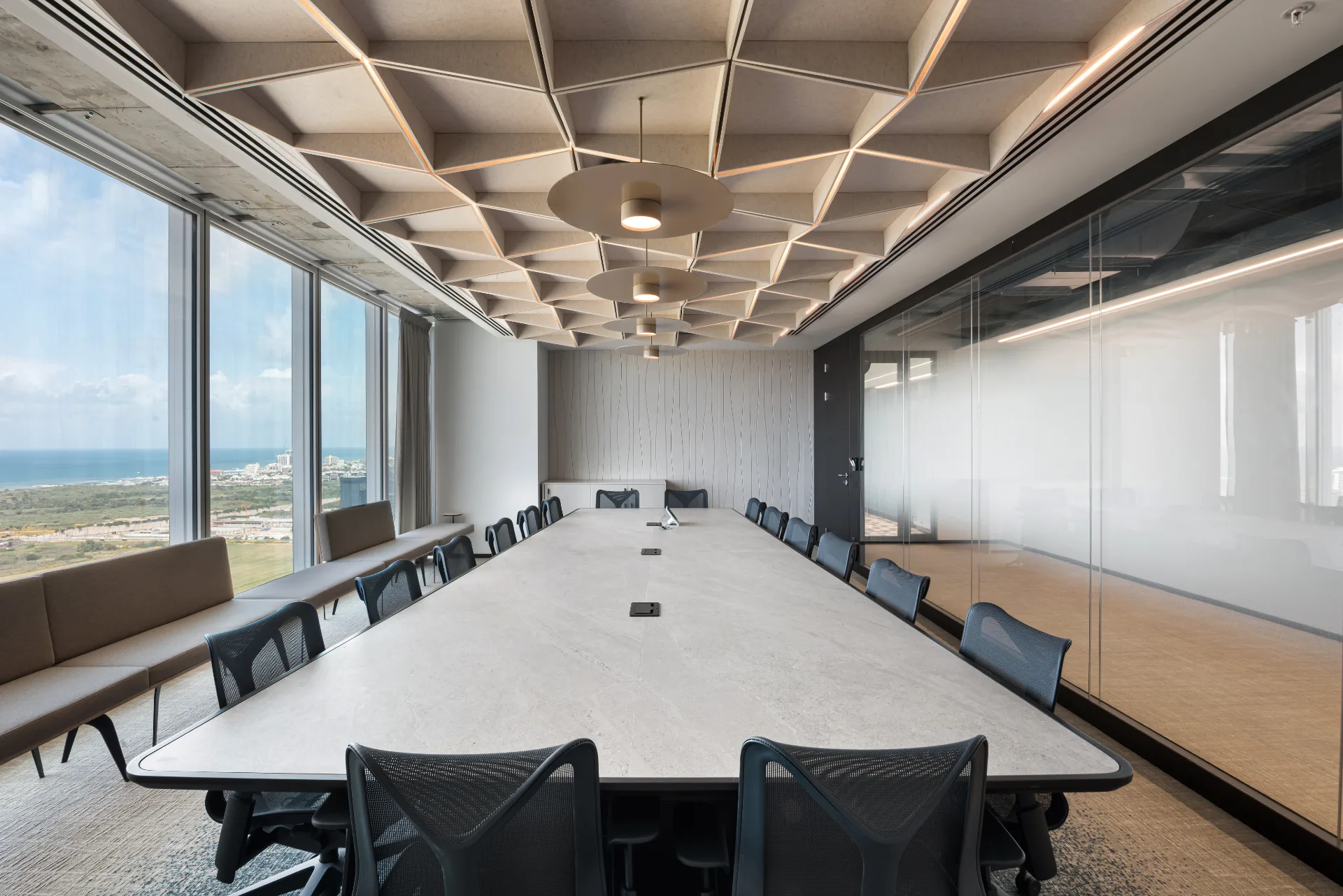 Boardroom with a light felt ceiling facing the sea