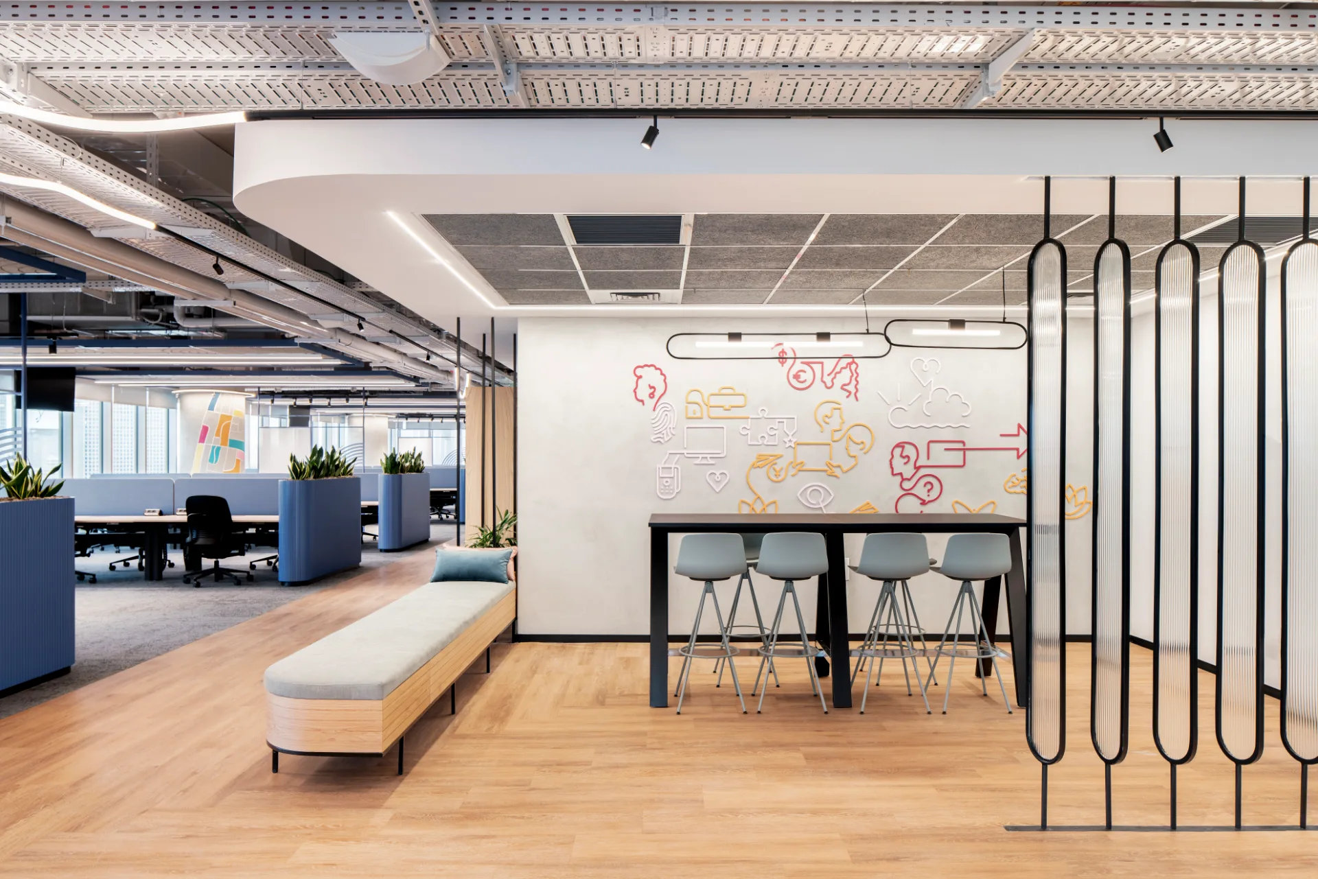 Shared bench facing a whiteboard wall