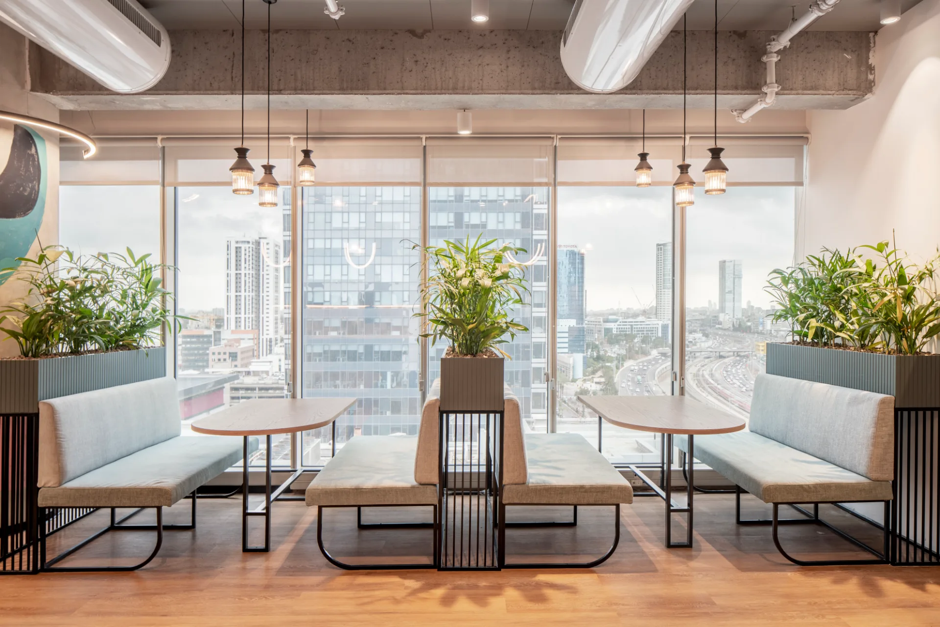 Upholstered booth seating along the windows