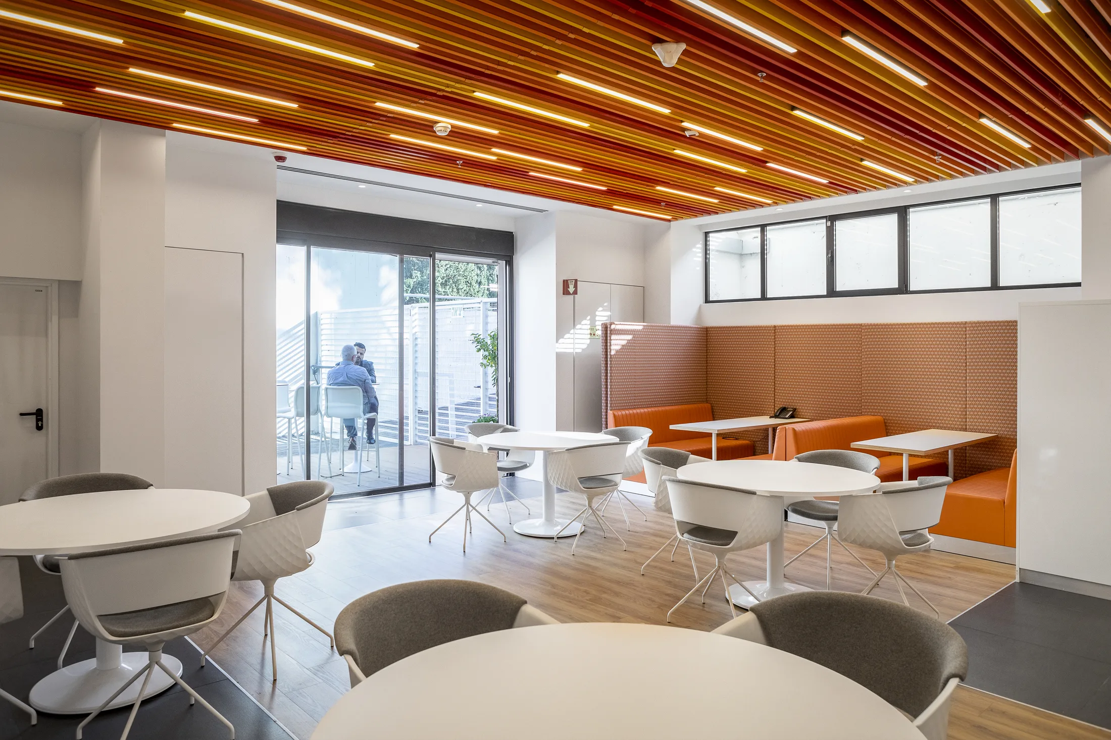 The café and breakout area under a timber-slat ceiling