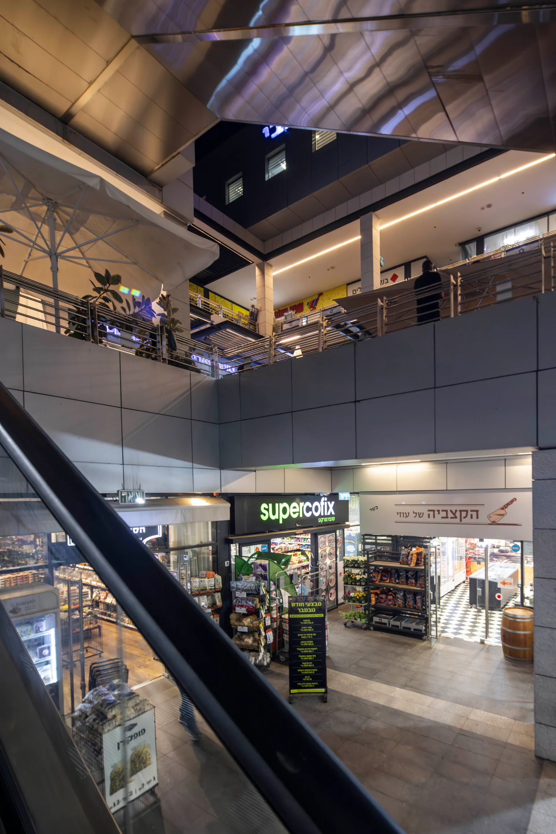 Covered concourse with supermarket frontage and stairs