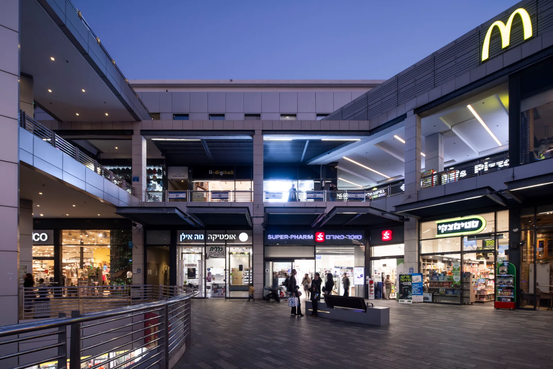 Retail arcade between the levels under linear lighting
