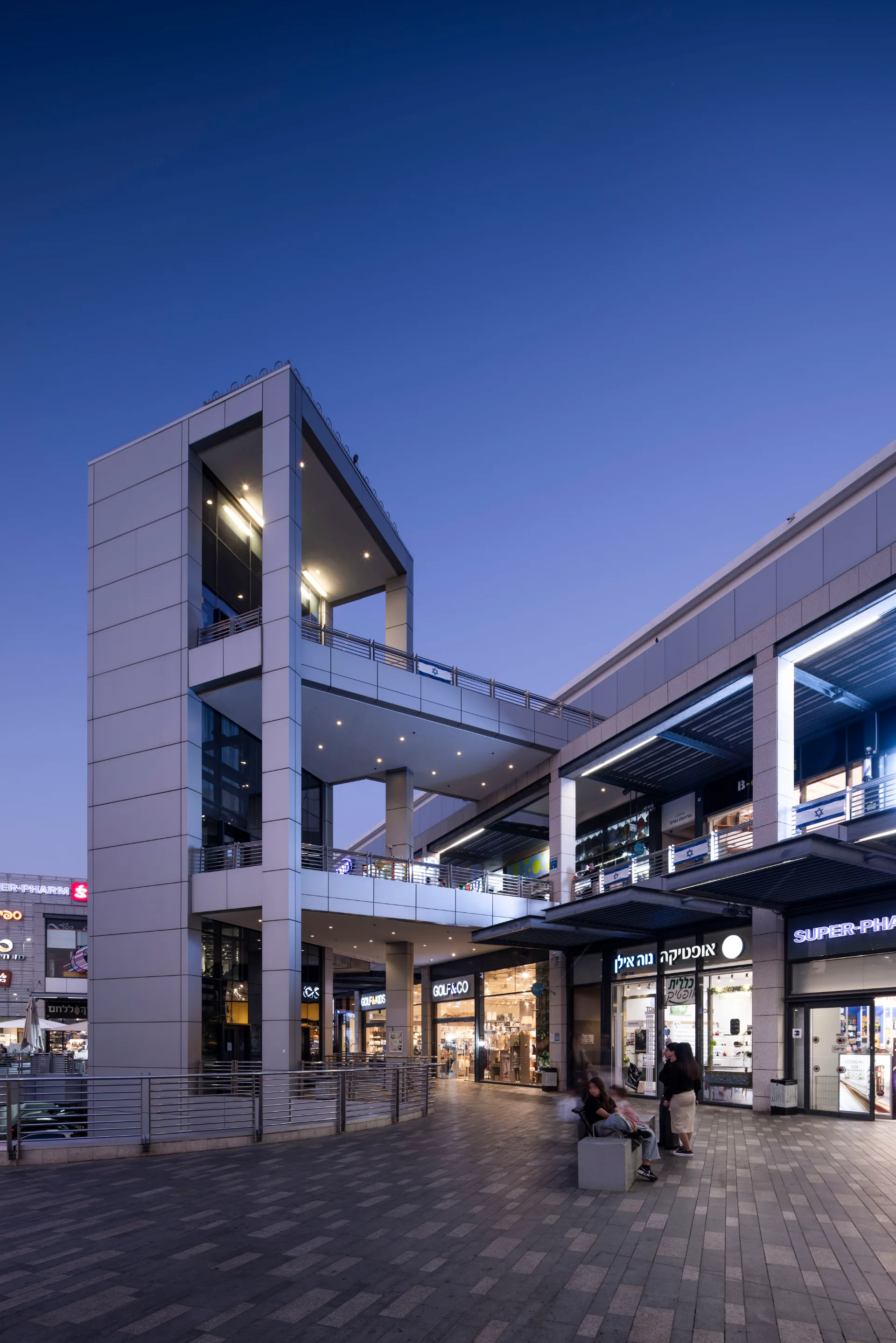 Multi-level facade and open galleries at dusk
