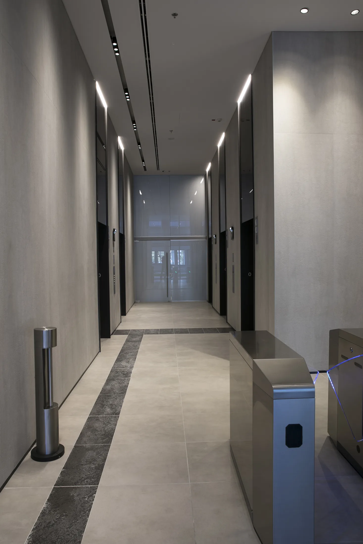 The elevator-lobby corridor in warm light