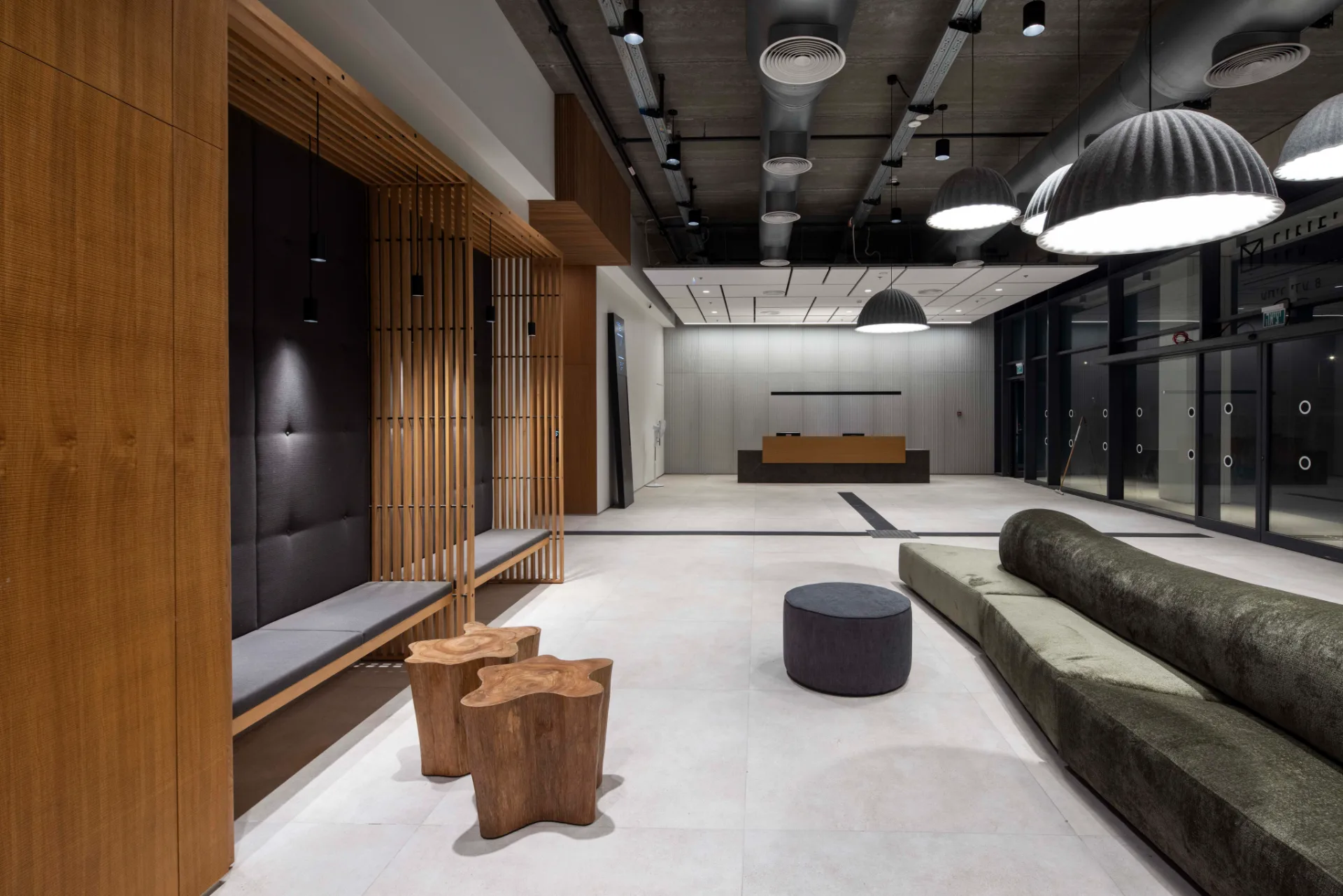 Common area with timber and dark cladding under an exposed ceiling