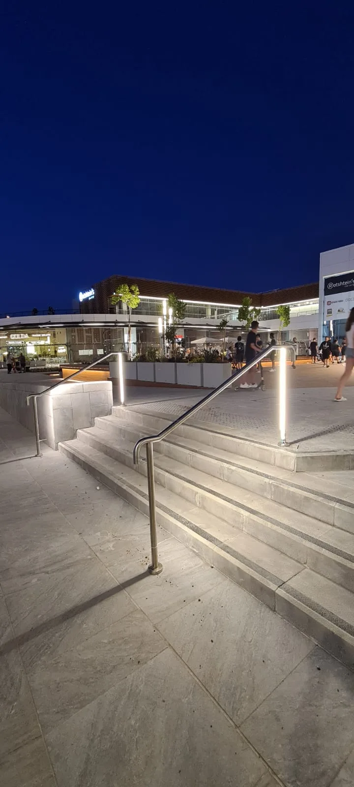Plaza steps and glowing poles in the evening