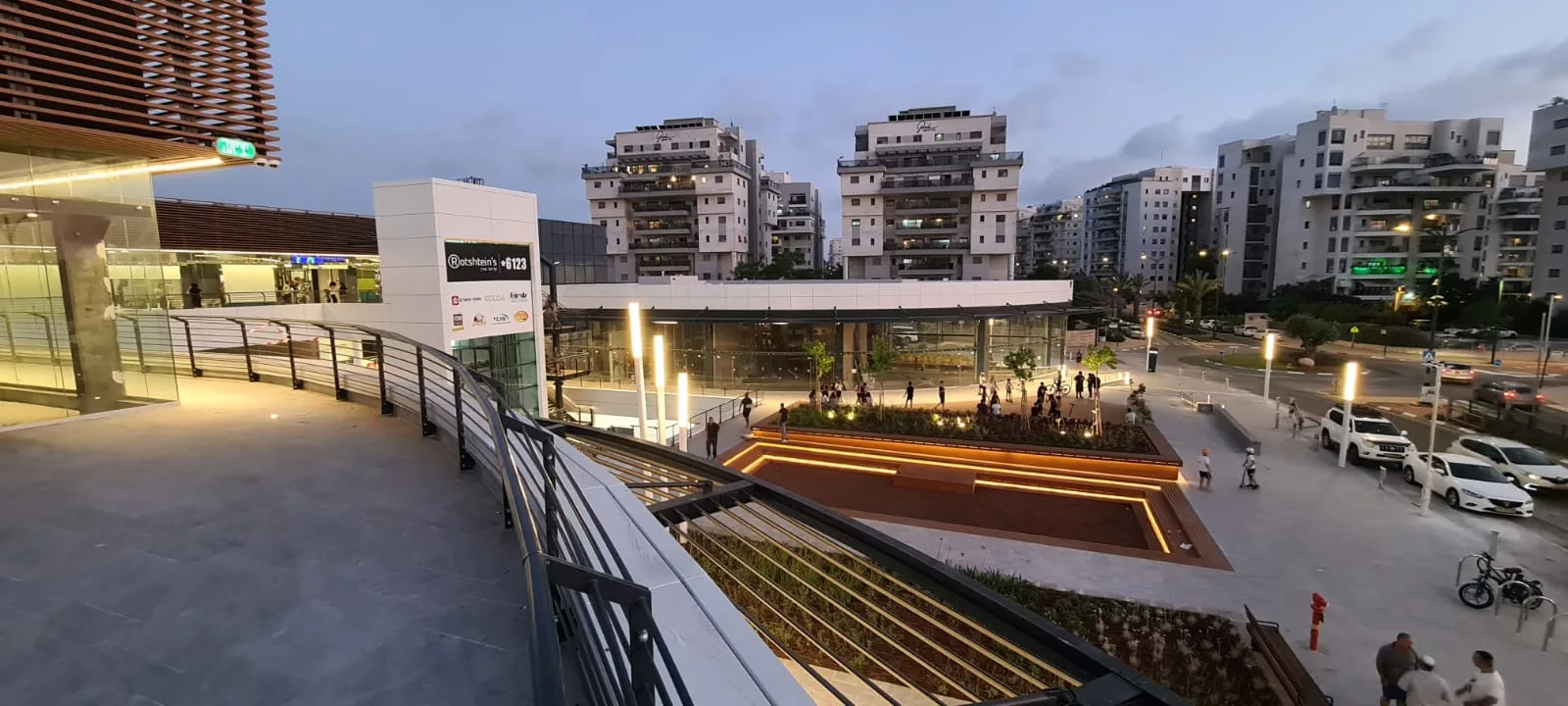 Public plaza and planted terrace with residential towers behind