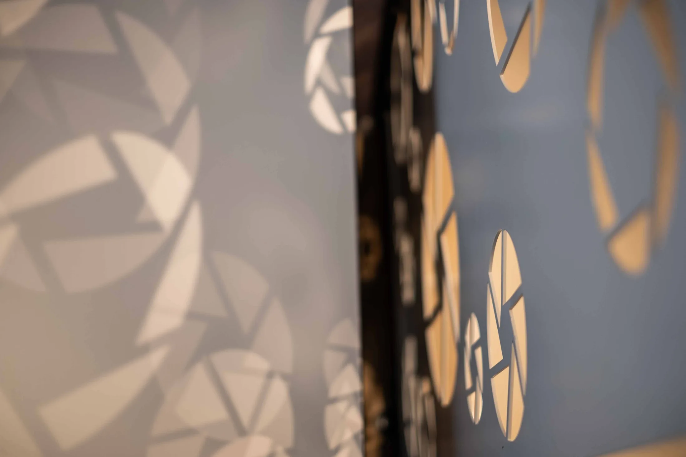 A detail of a decorative light-and-shadow pattern projected on the wall