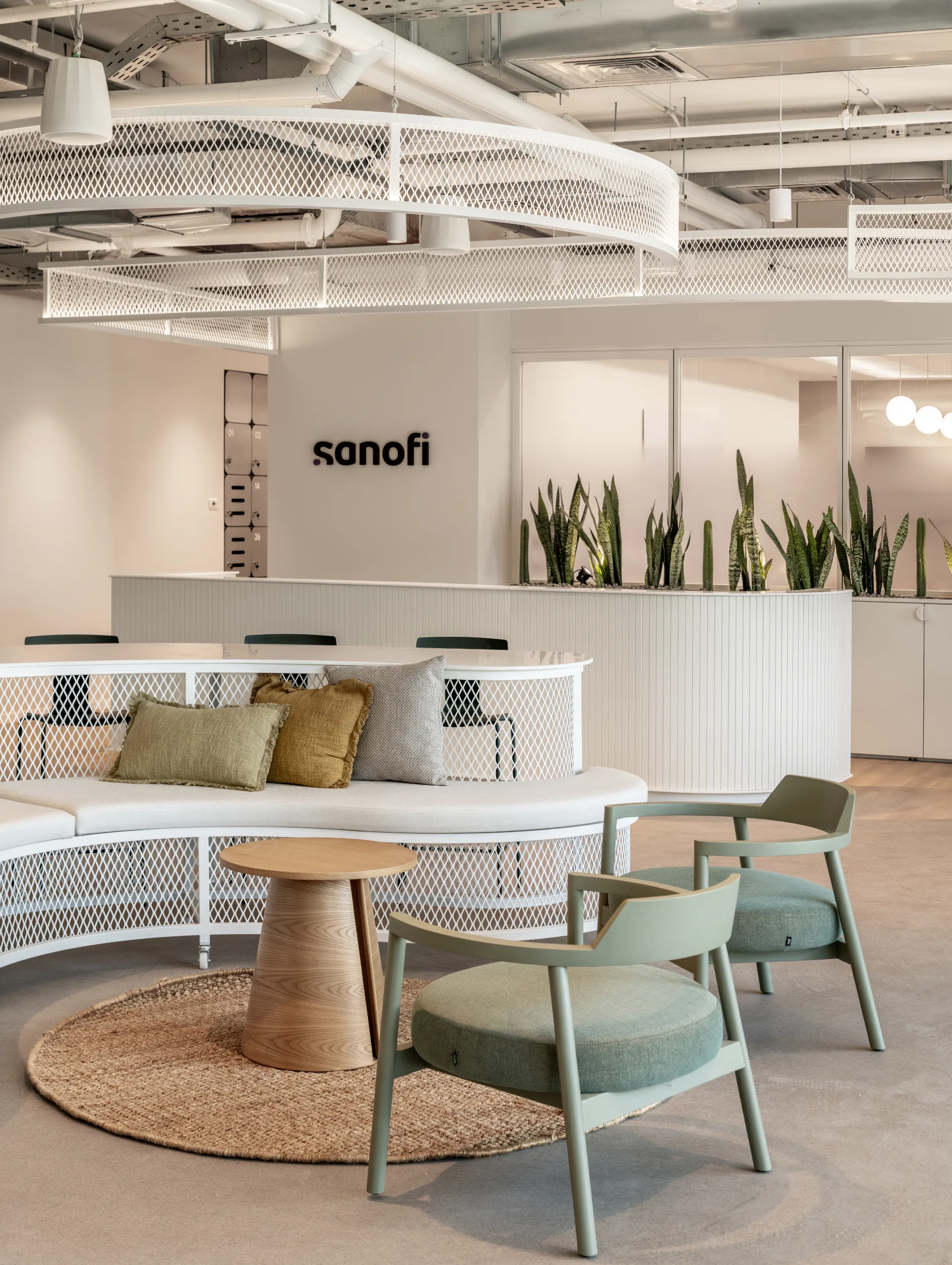 Reception area with the sanofi logo and soft seating