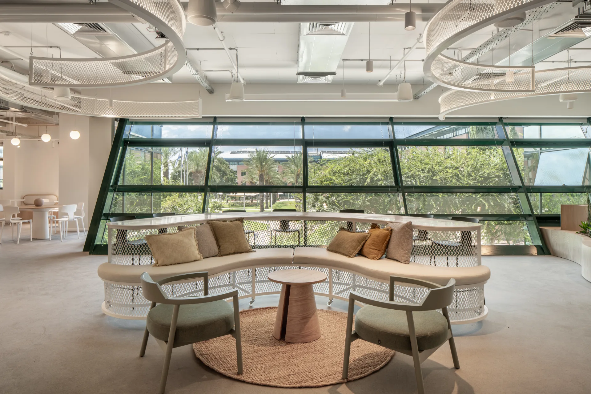 Curved lounge beside the angled glazing with ceiling rings