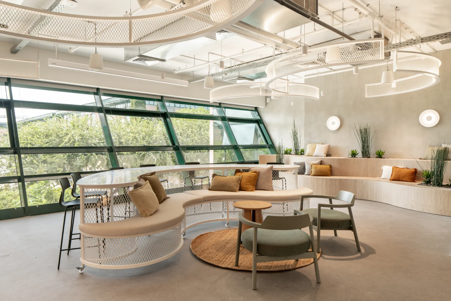 Curved banquette beneath sculptural ceiling elements