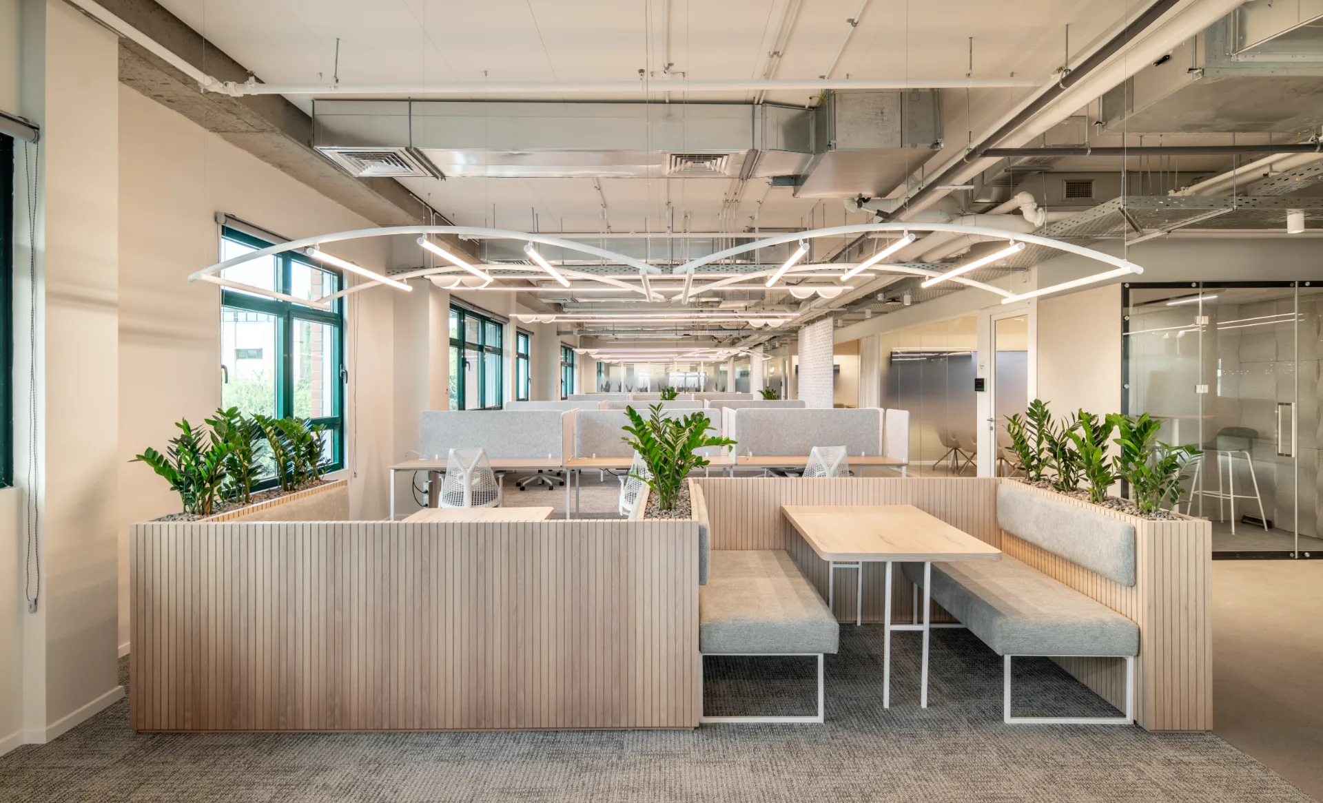 Open workspace beneath a grid of light lines