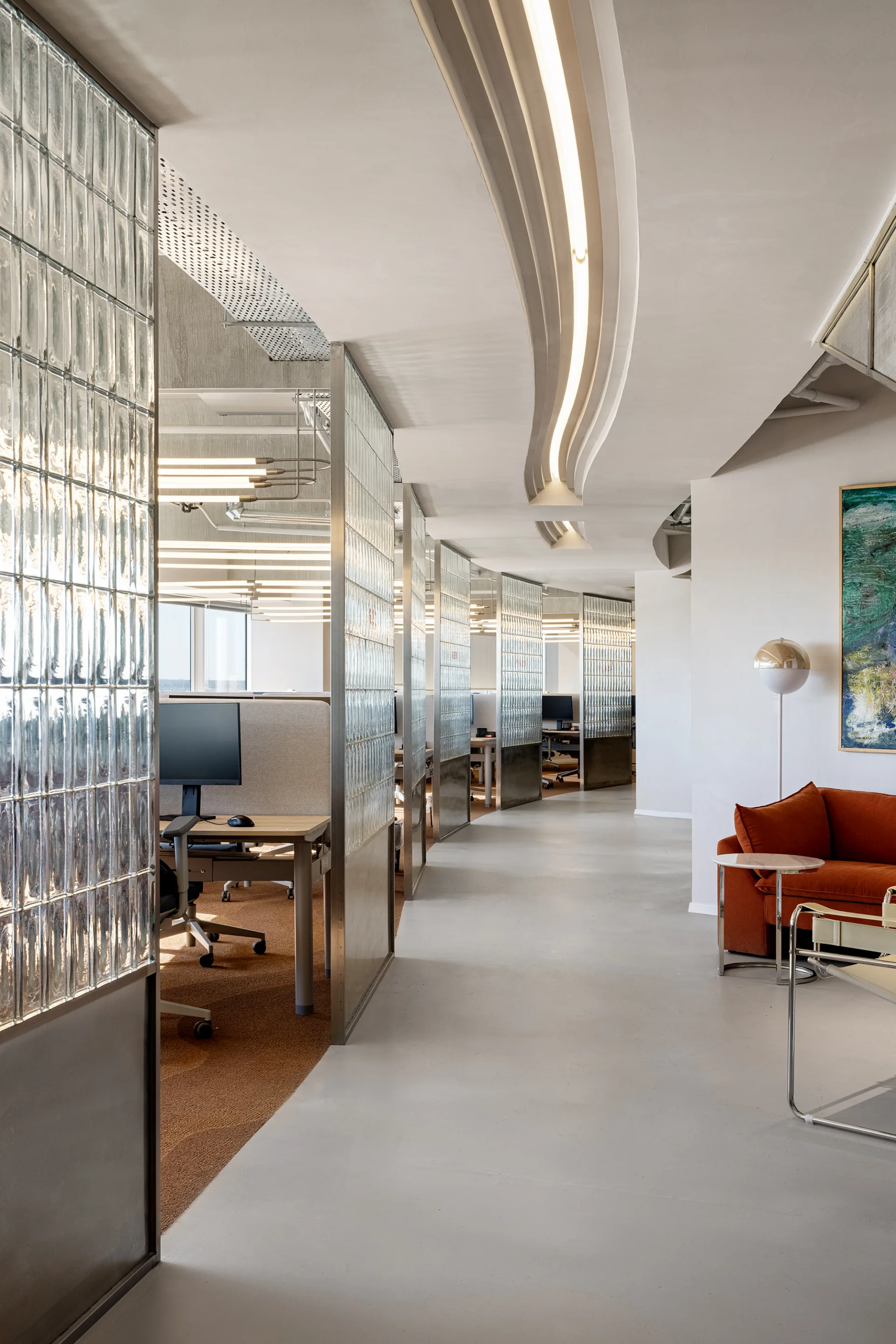 Open workspace beside glass-partitioned offices