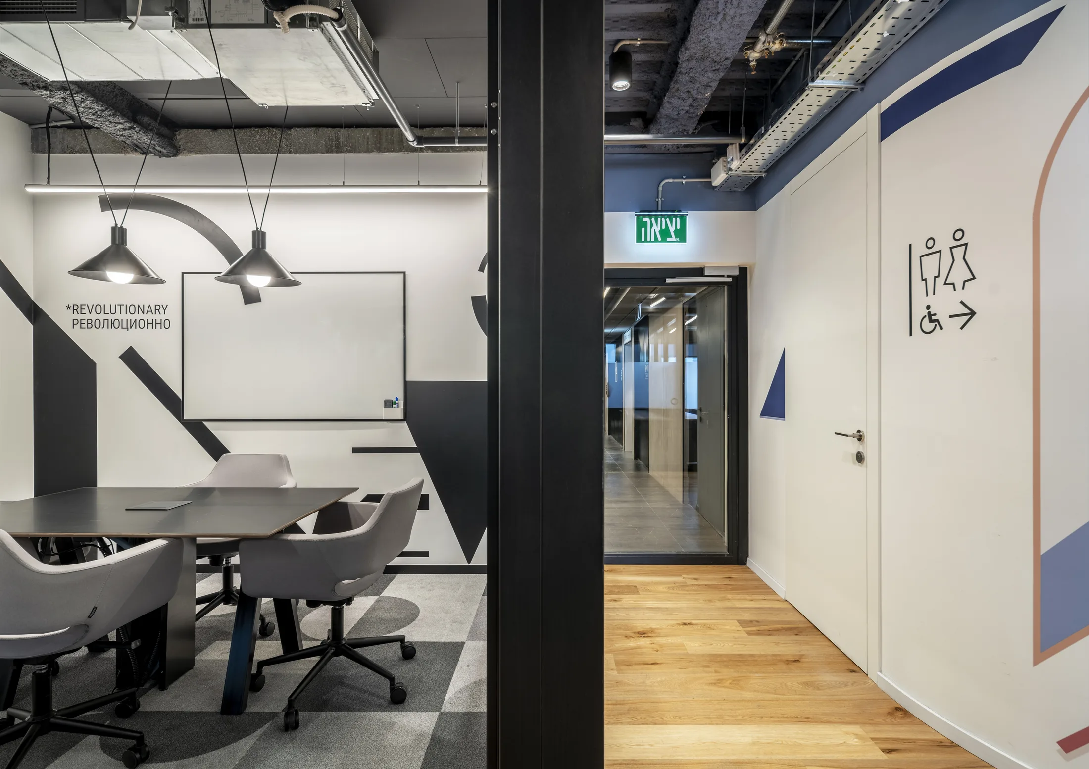 A small meeting room with dome pendants and graphic walls
