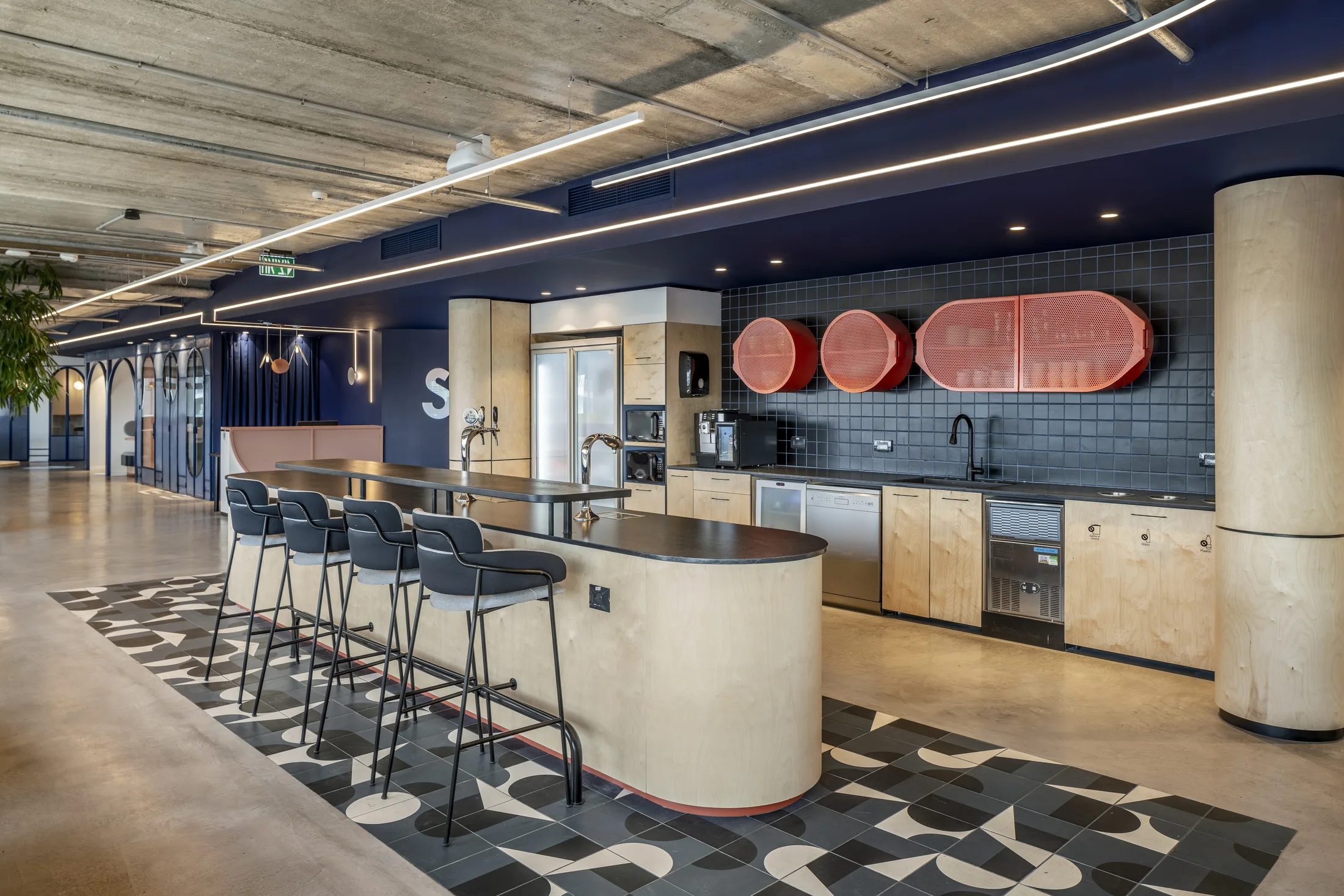 The kitchen island and bar under linear lighting