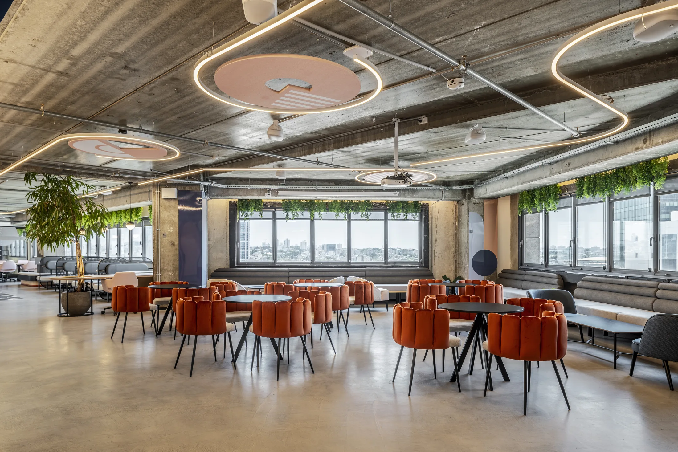 Café seating beneath circular light rings and disc panels
