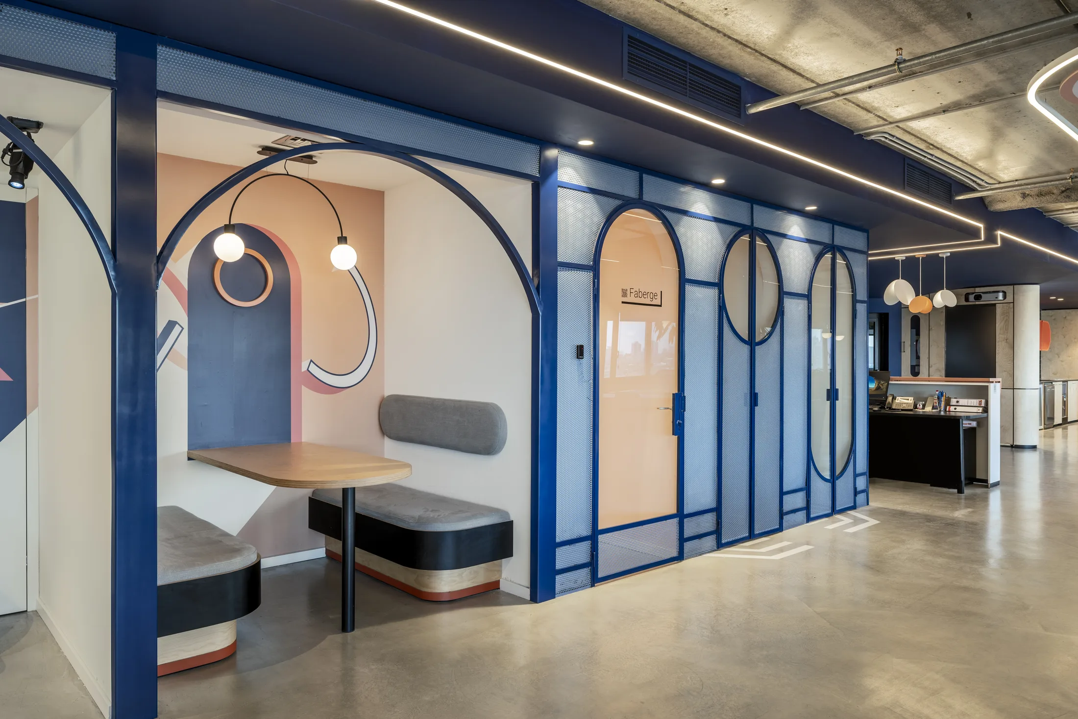 Blue arched phone booths with globe pendant lights