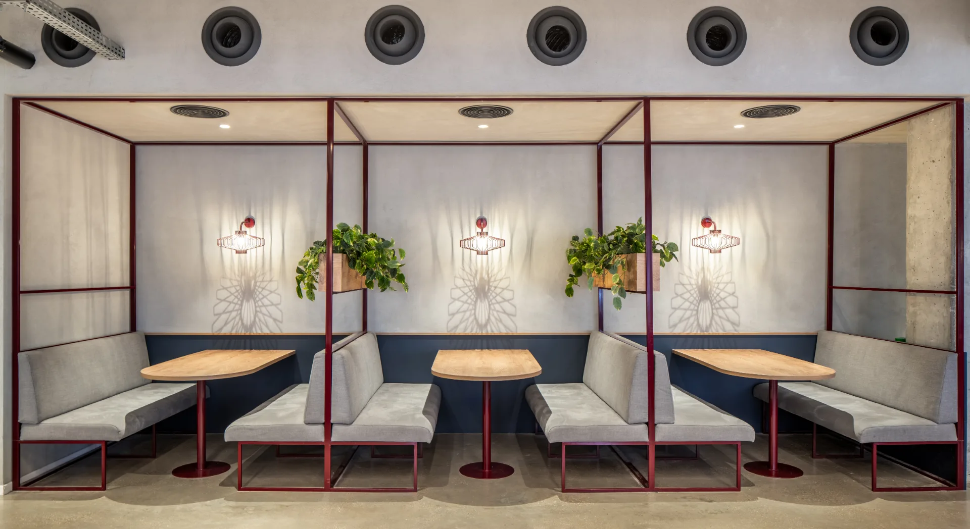 Upholstered booths with hanging planters