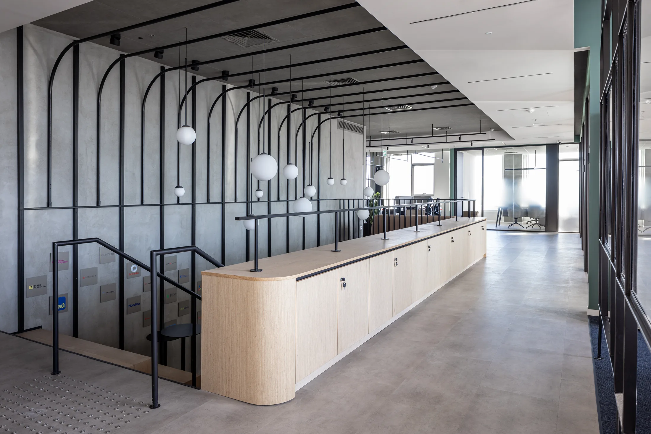 A feature stair with arched steelwork and globe pendants