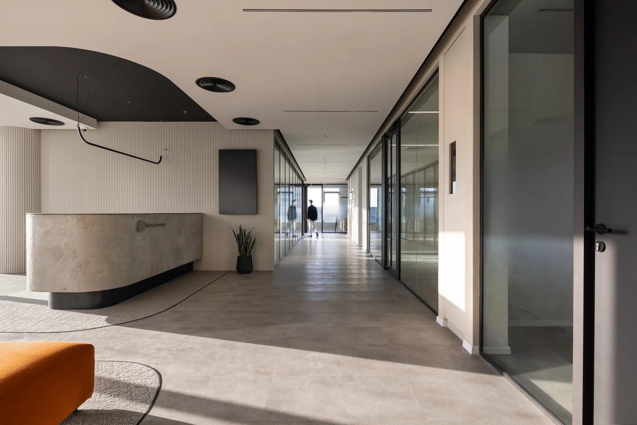 The reception desk and glazed corridor at the entrance