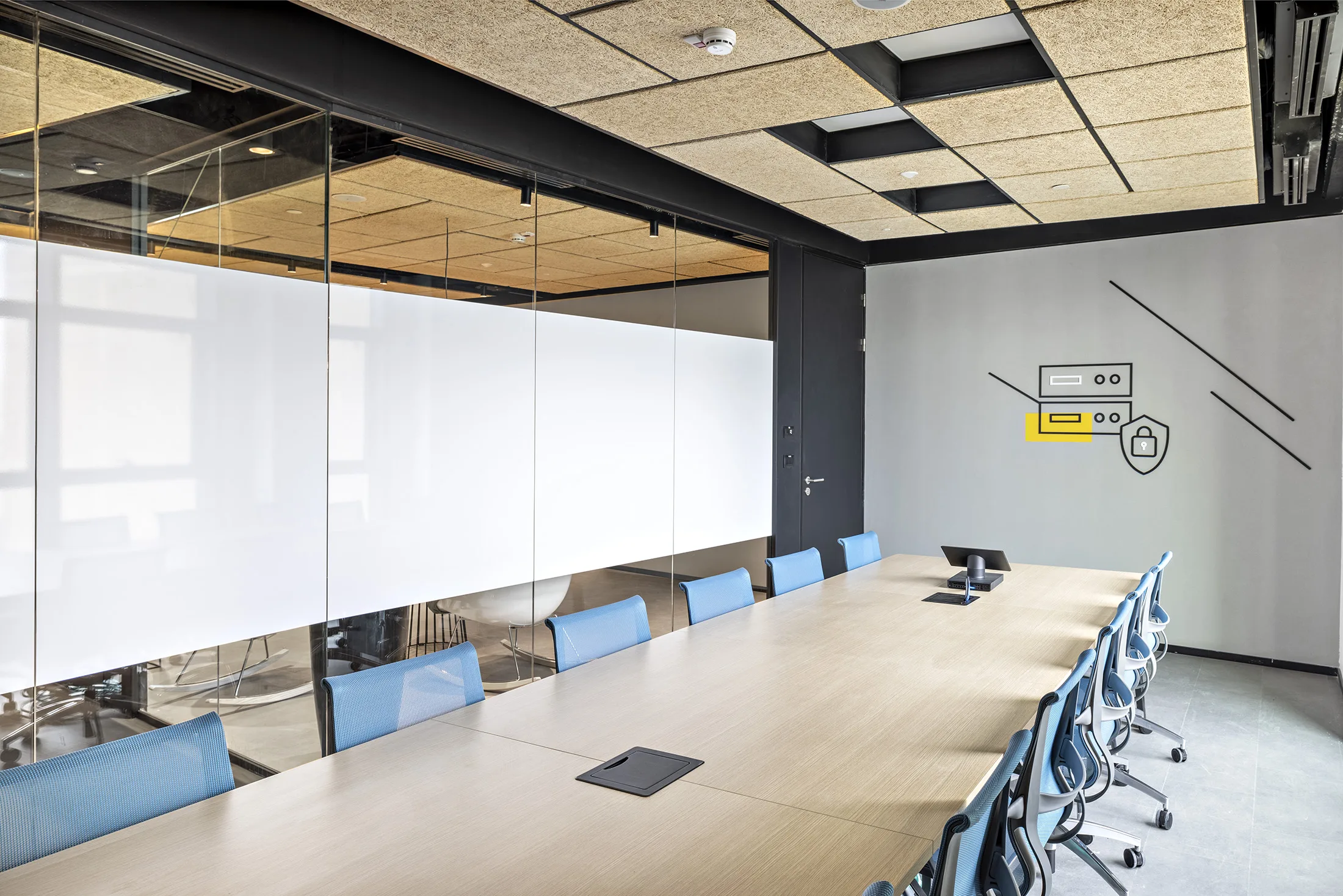 A glazed boardroom with a wood acoustic ceiling
