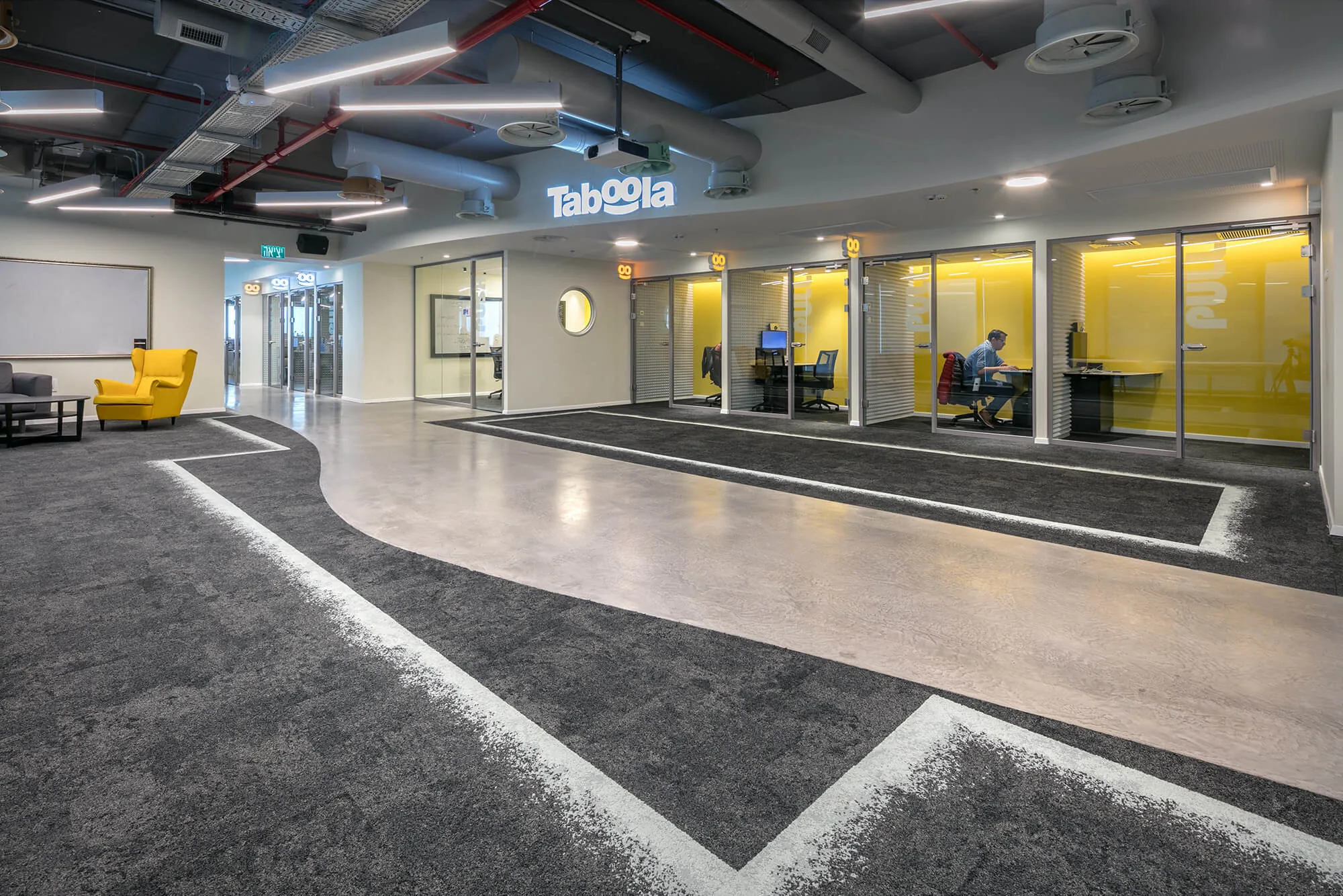 The branded reception with yellow meeting pods