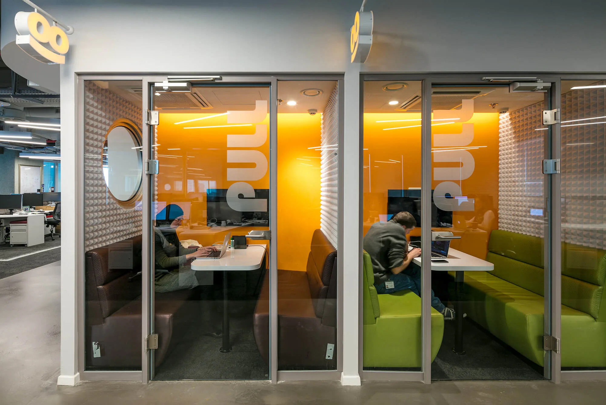 Orange-lined focus booths with banquette seating