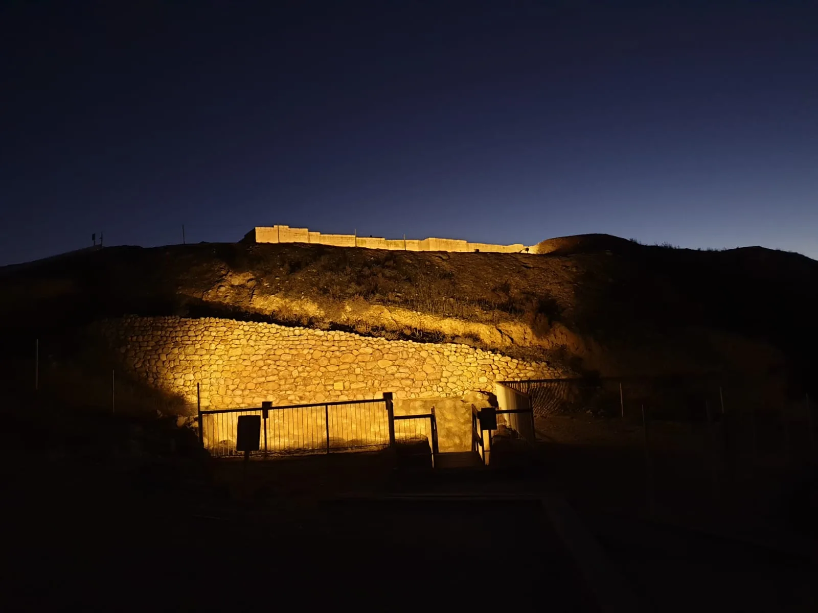 Ancient stone wall of the tel grazed with light