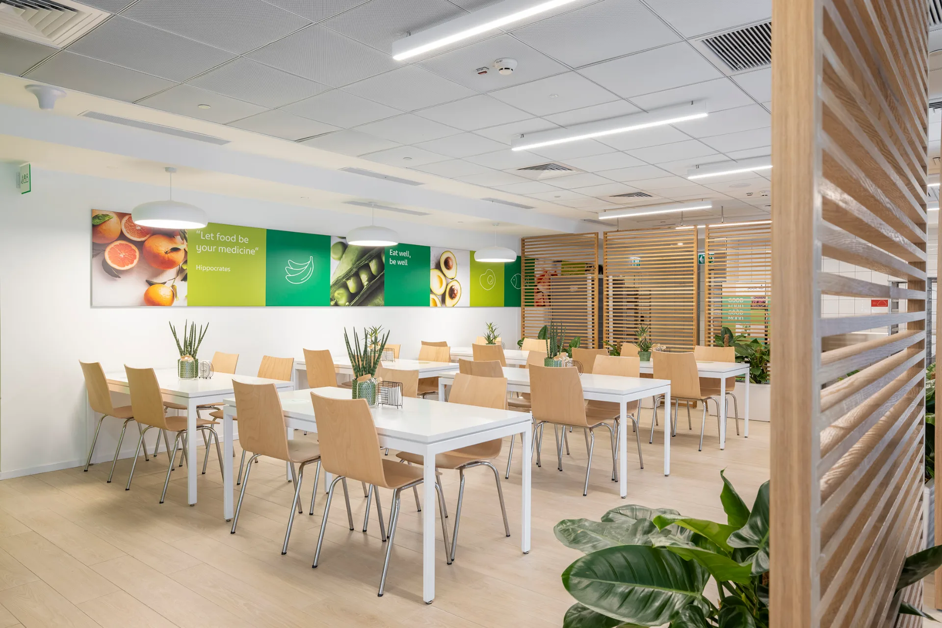 Open workspace beside glazed meeting rooms