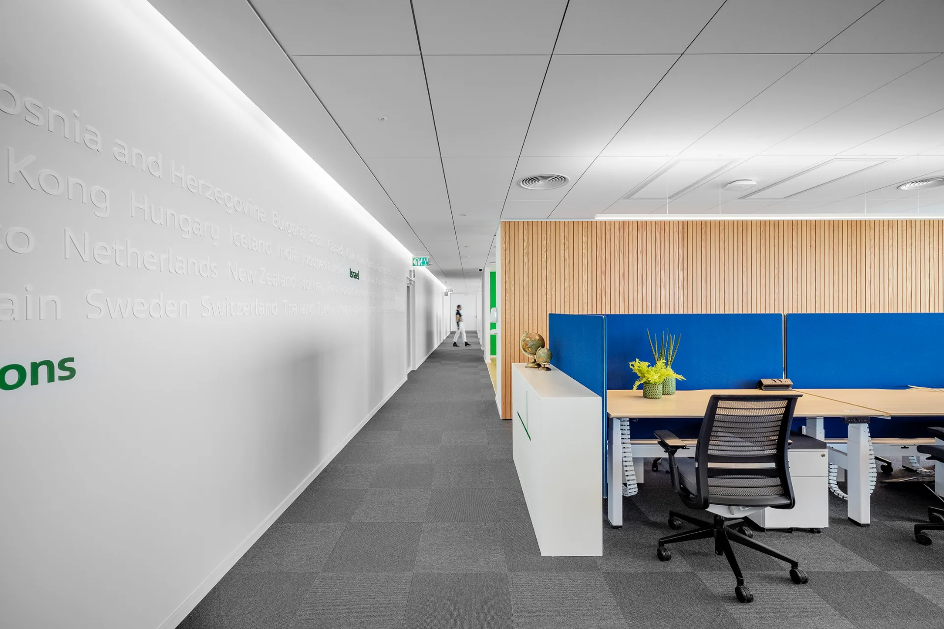 Workstations along a glazed facade with city views