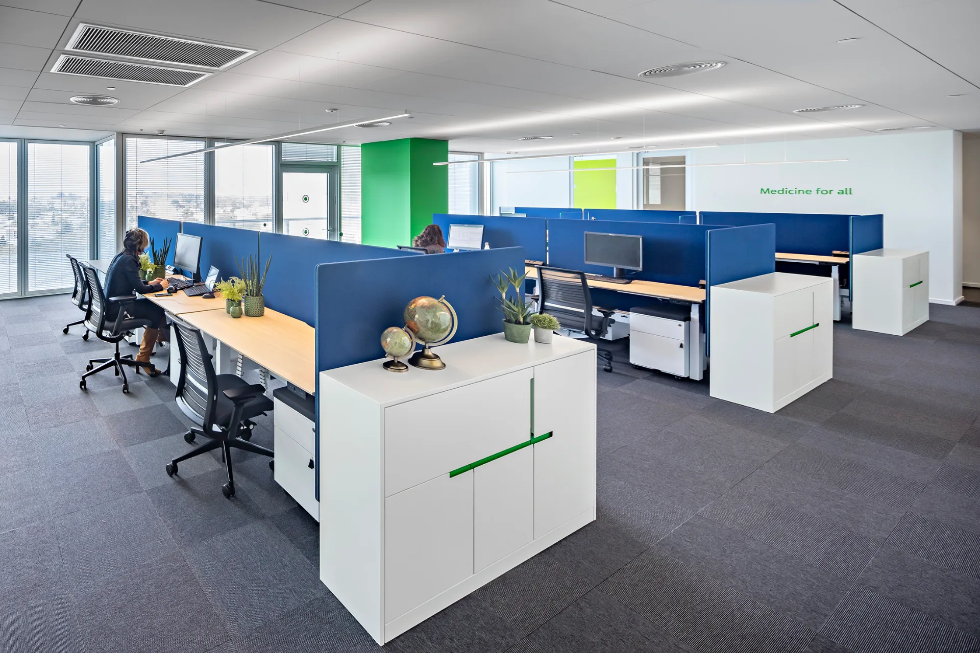 Open work area beside full-height windows