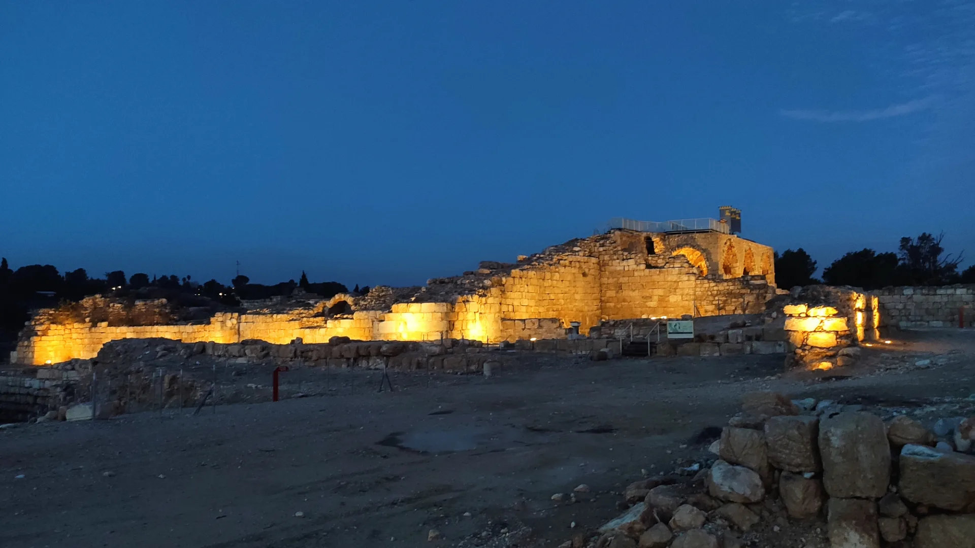 The fortress ruins uplit at dusk