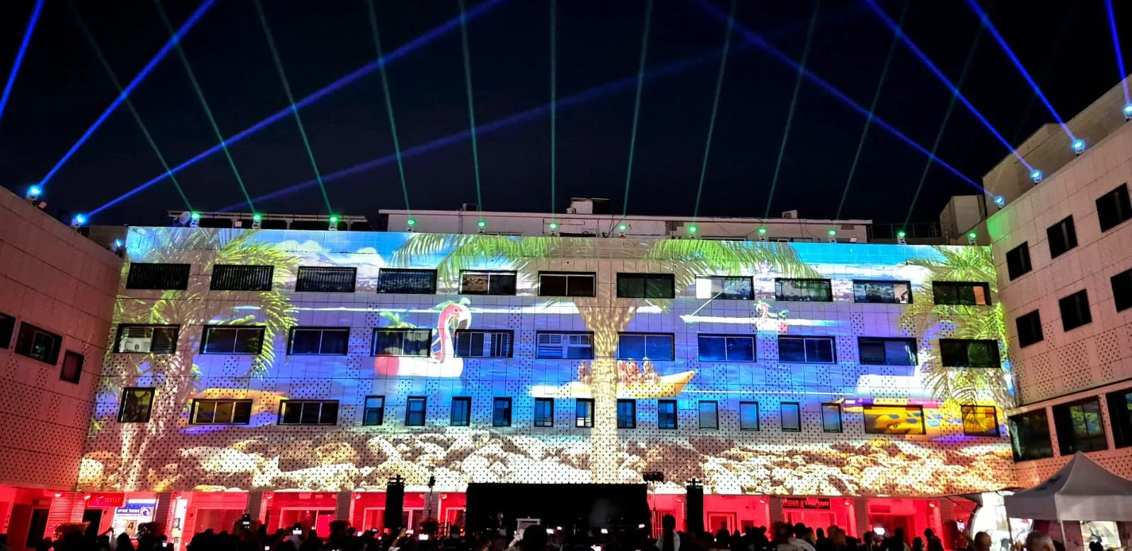 Projected scenery and crossing light beams above the plaza