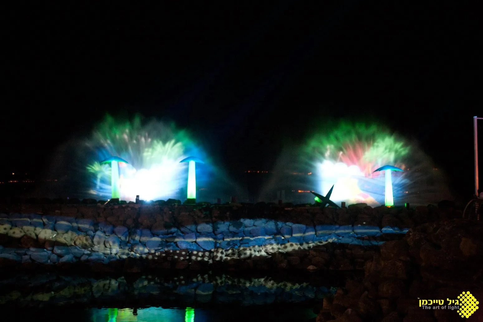 Projection and light bursts over the show platform