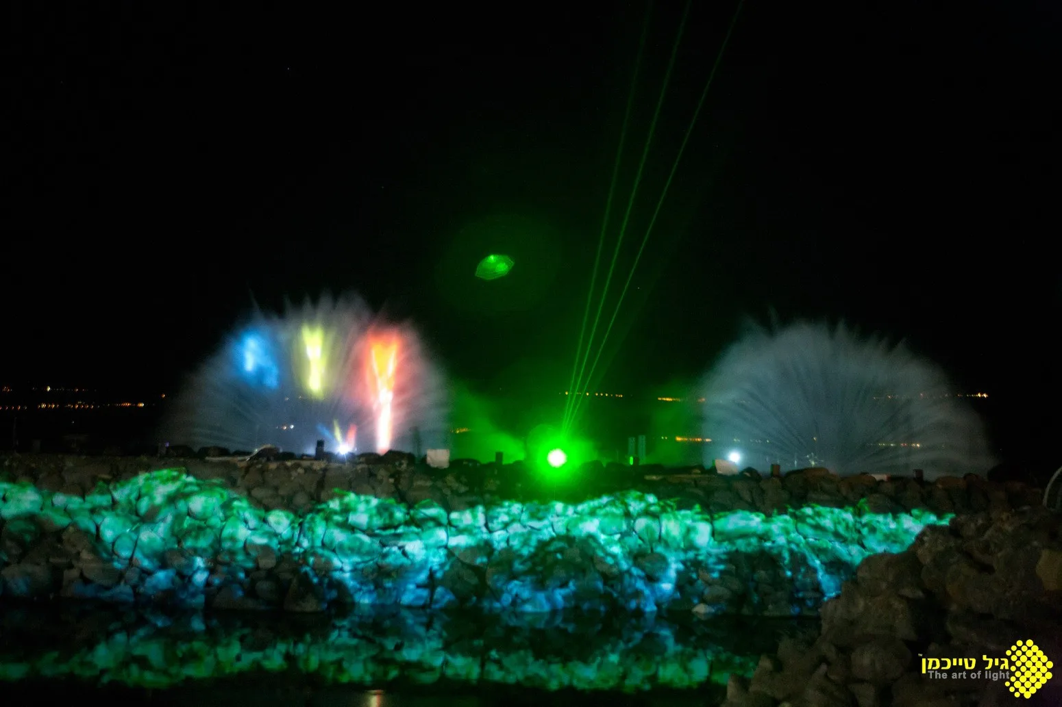 Green laser beams and water-mist projections