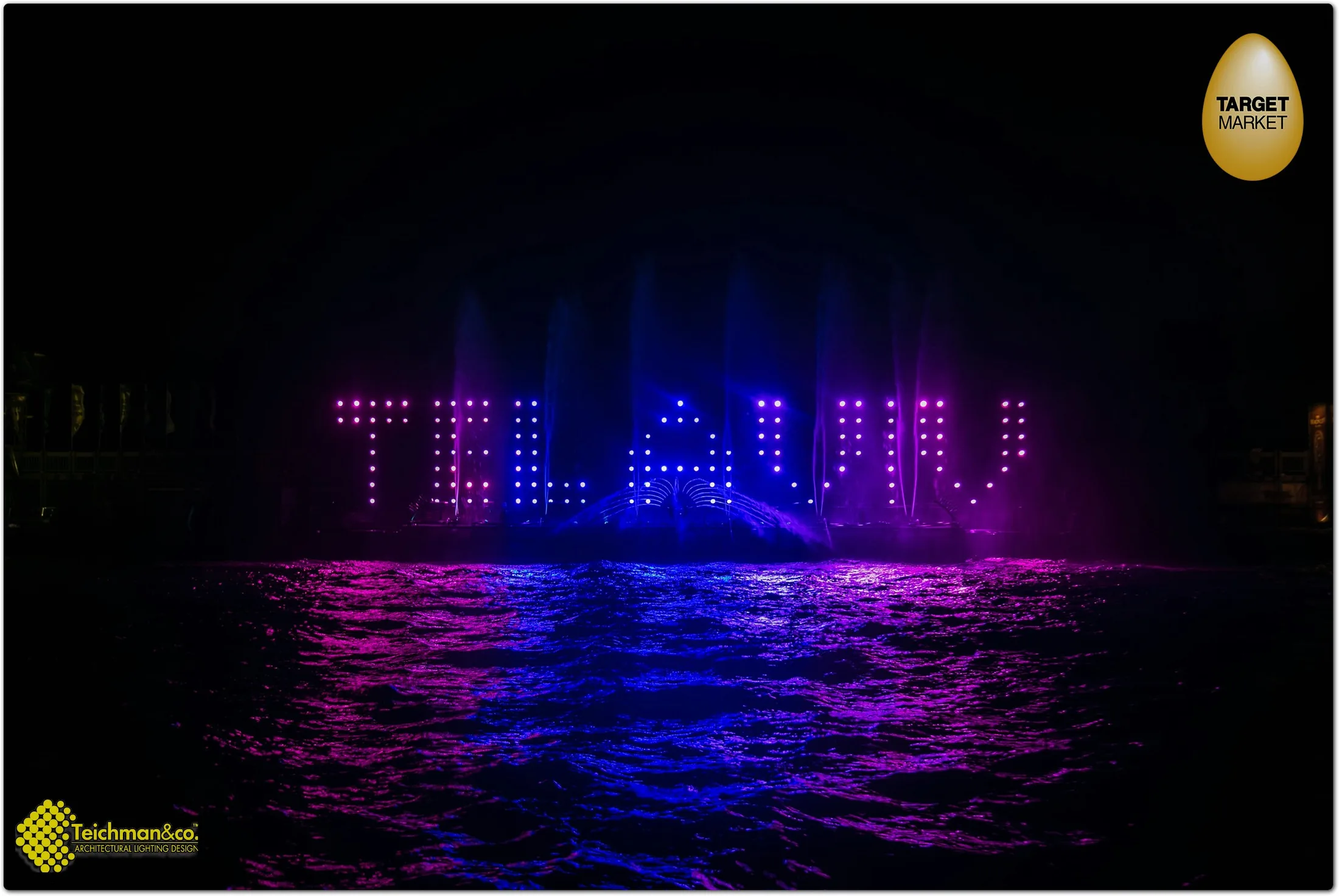 The light screen spelling 'Tel Aviv' over the water