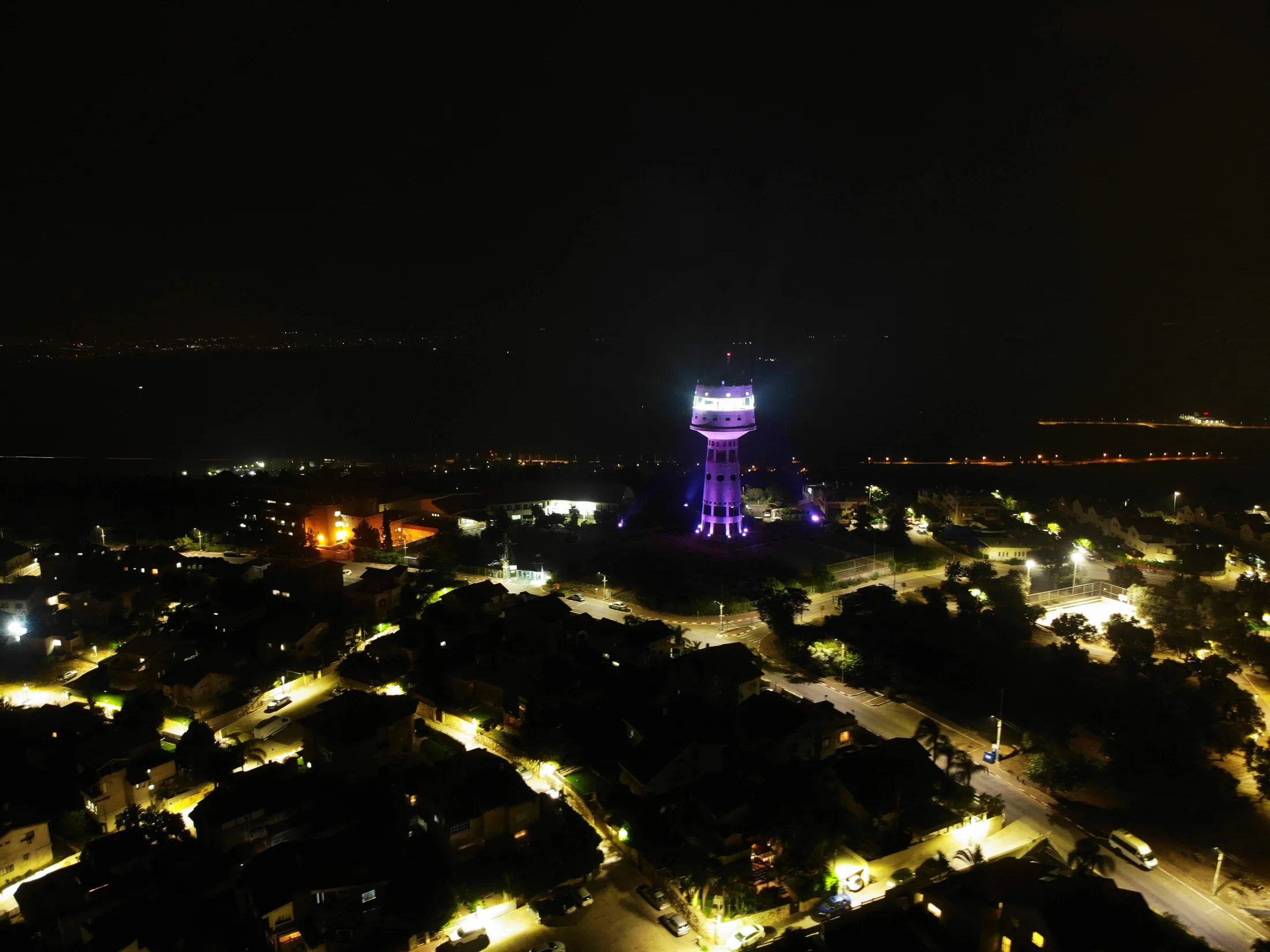 The lit tower as a beacon over the valley at night