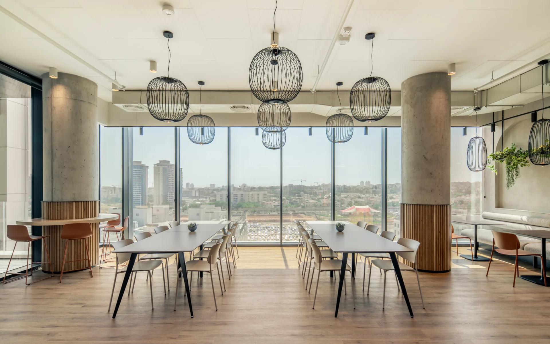 Dining area with wire pendant lights and city views