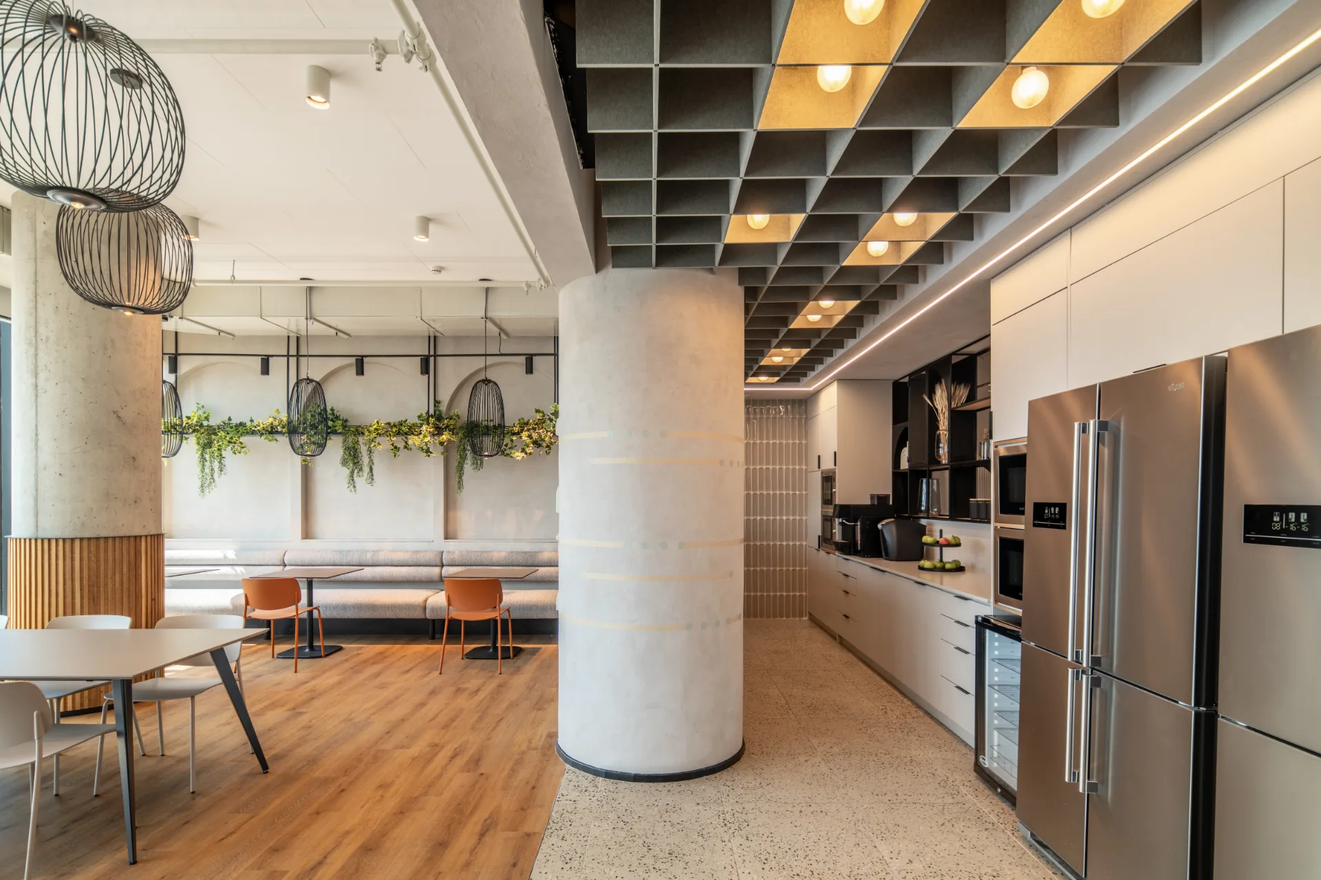 Kitchenette and gathering area beneath an exposed ceiling
