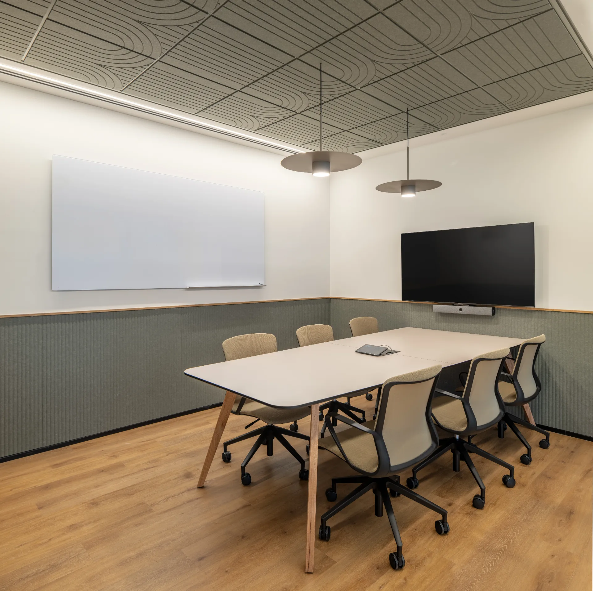 Meeting room with banquette seating and a whiteboard