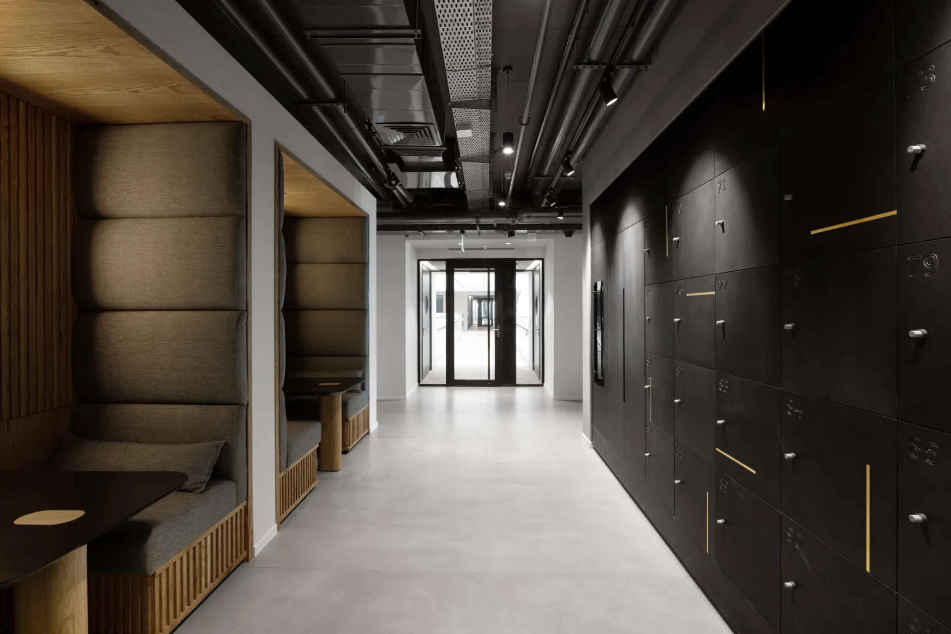 Acoustic work booths beside a locker wall