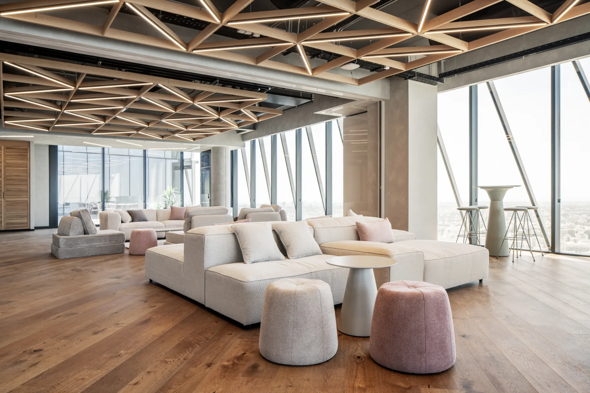 Town-hall lounge beneath timber beams and an exposed ceiling