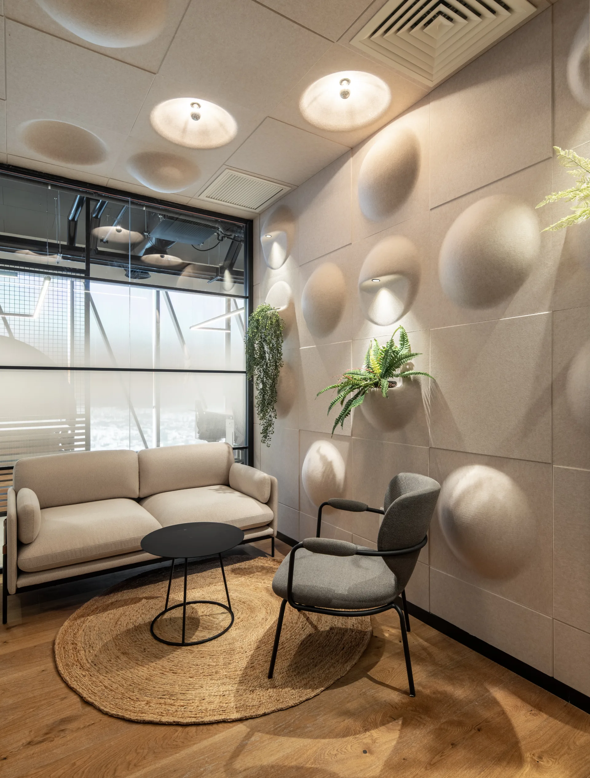 Quiet lounge with a sculptural acoustic wall